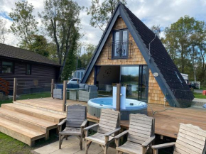 Widgeon Bespoke Cabin is lakeside with Private fishing peg, hot tub situated at Tattershall Lakes Country Park